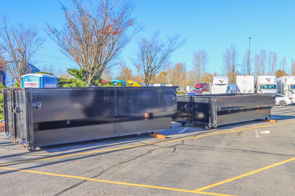 Professional dumpster rental service with roll-off container on residential driveway in Ketchikan